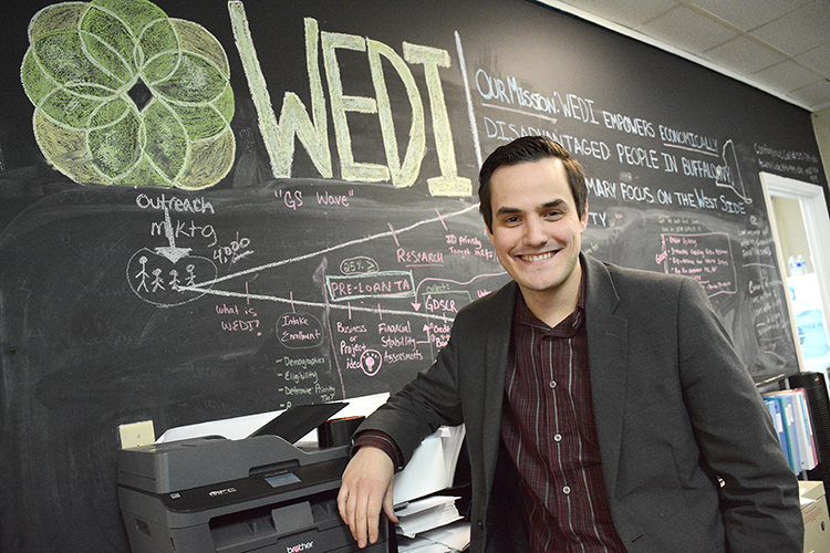 Benjamin Bissel, executive director of the Westminster Economic Development Initiative, stands in front of the “mission board” in his Grant Street headquarters. 