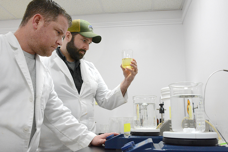 Mike Andrews and Justin Schultz blend CBD products in their laboratory at 1100 Military Rd. in Kenmore, N.Y.