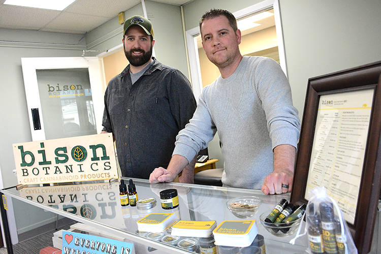 Bison Botanics owners Mike Andrews and Justin Schultz at the counter of their walk-in shop.