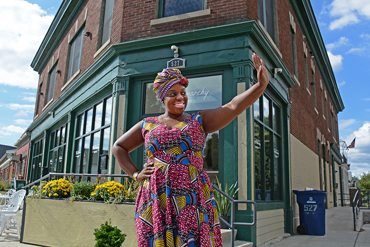 Phylicia Dove, owner of Black Monarchy, waves to a friend in front of her West Side store at 527 West Utica St. on Buffalo’s West Side.
