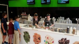 Children line up for a scoop of cookie dough.