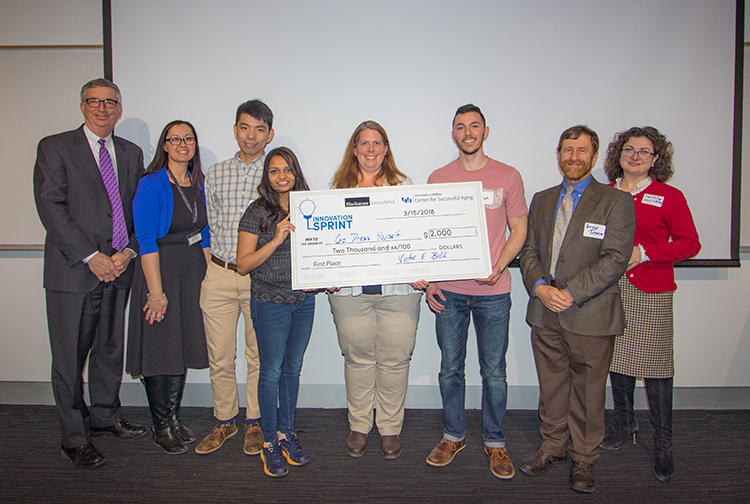 Team members from Go Dress Yourself (starting third from left) Wei Lin, Harsha Kosta, Kim Persons, and Joseph Whaley earned first-place honors, and a check for $2,000, as the winners of UB’s recent innovation challenge.