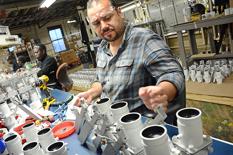Litelab employee Ahmed Al Abboodi, who came to Buffalo from Iraq four and half years ago, assembles AO4 projector light fixtures at the downtown Buffalo facility. 