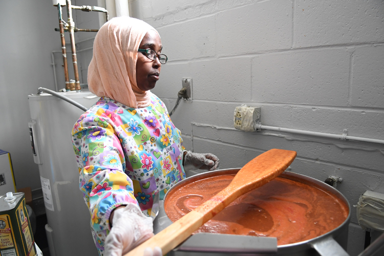Bisharo Ali, owner/creator of Najah savory sauces, at work in her kitchen.