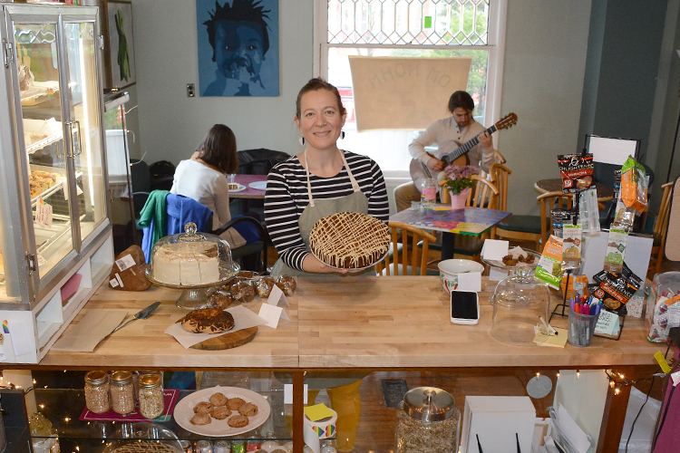 Jessamine Daly-Griffen, owner of Om Nohm Gluten Free, holds one of her creations at her Temple Street shop. 