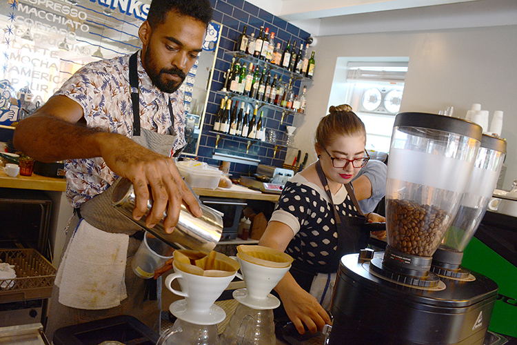Remedy House employees Sami Tucker and Robin Carman whip up gourmet expresso and macchiato at the café, located at Rhode Island and West Utica streets. 