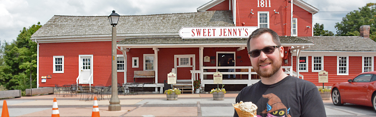 Howard Cadmus stands outside of his popular confection and ice cream shop. Built in 1811, the building originally operated as a saw mill.