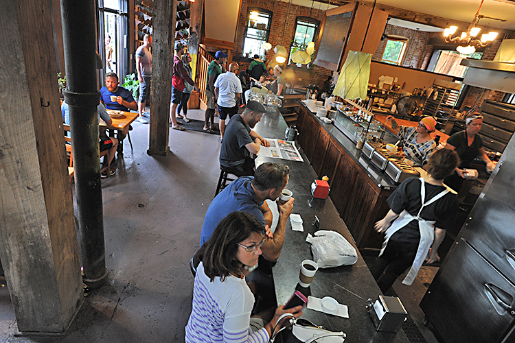 The breakfast crowd enjoys hot coffee and yummy food at the Five Points Bakery, located at the corner of West Utica and Brayton streets.