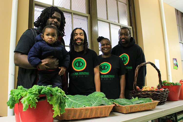 Alex Wright of the African Heritage Food Co-op, with his son and friends.