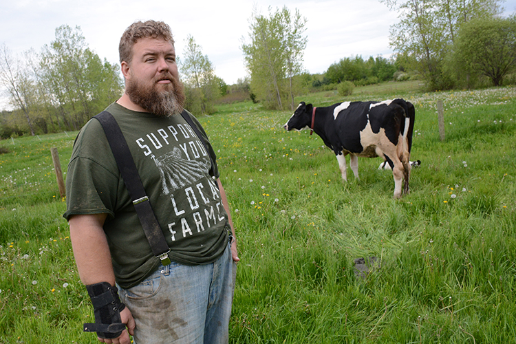 Michael Parkot stands near one of his Holstein cows. He specializes in raising meat animals that he provides to area restaurants.