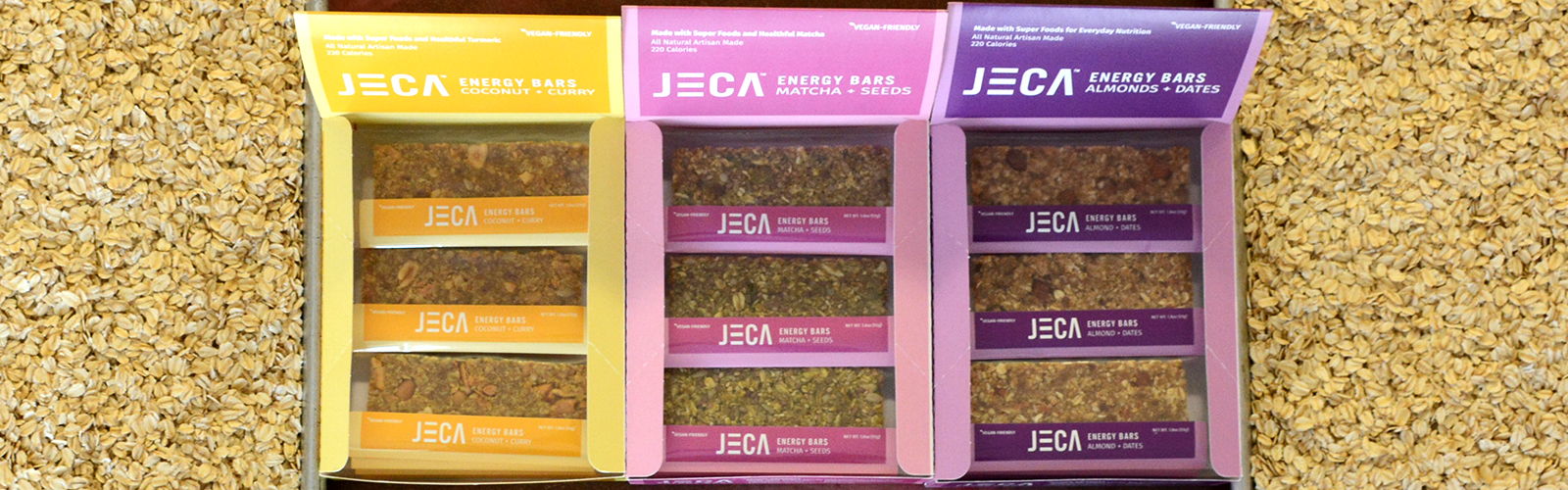 Framed by trays of toasted oats, Jeca Energy Bars in almonds/dates, coconut/curry and matcha/seeds.