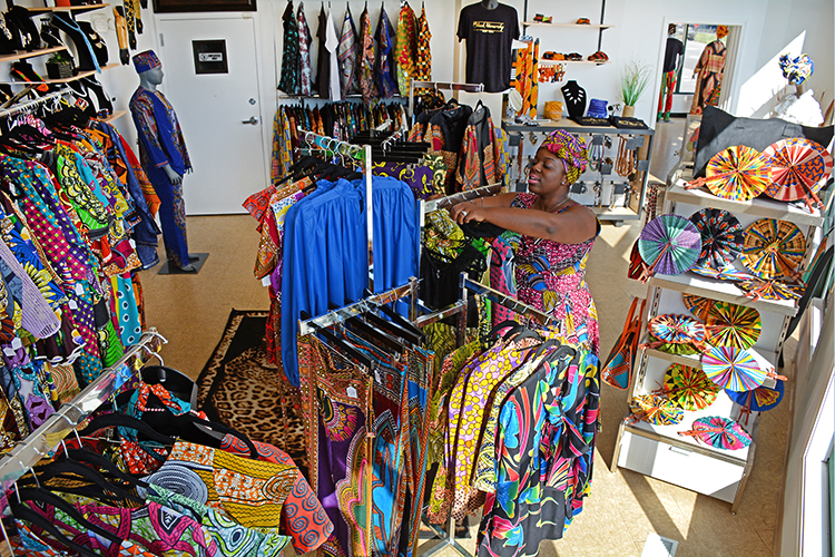 Phylicia Dove organizes her stock at the global artisan and fashion boutique she launched in 2016. She opened its first brick and mortar in 2017 and expanded this year.