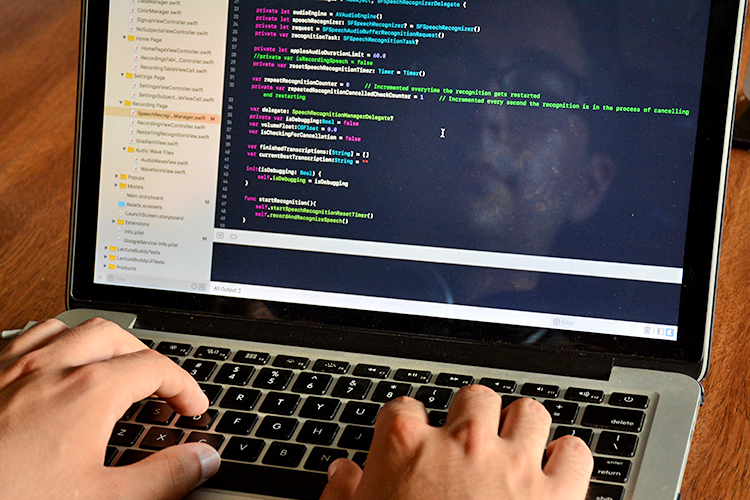 University at Buffalo student Arthur De Araujo writes code in the community room of his apartment complex.