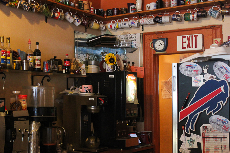 Mugs and coffee paraphernalia adorn the walls of EmTea Coffee Cup Café. 