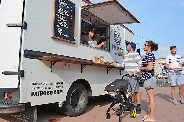 Patrons order food from Fat Bob’s food truck, which specializes in Southern BBQ and its famous mac and cheese.