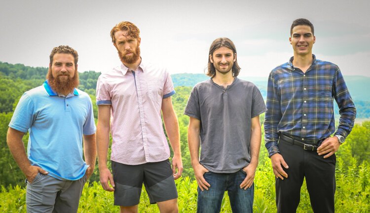 Sal LaTorre, Matthew Berke, Gabe Bialkowski, and Jake Sainz on the hilltop of their property.