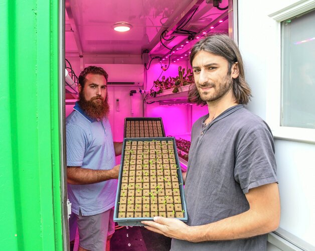 Sal LaTorre and Gabe Bialkowski grow sprouts in the grow pod next to the barn in which they plan to host live events.