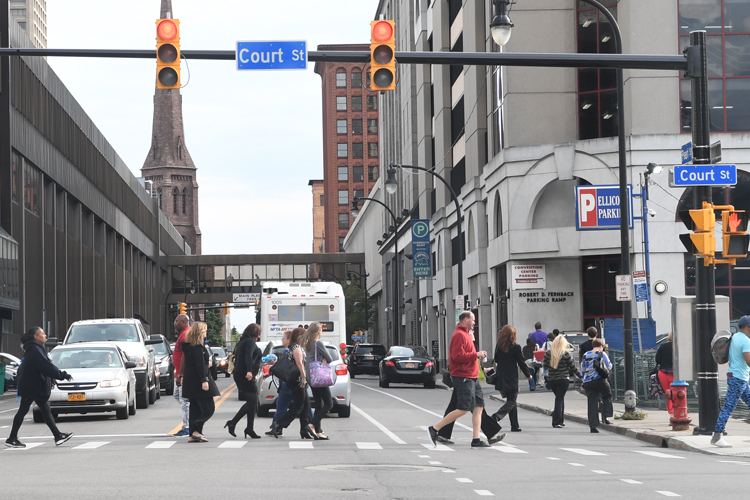 Workers in downtown Buffalo, New York, walking along Court Street.