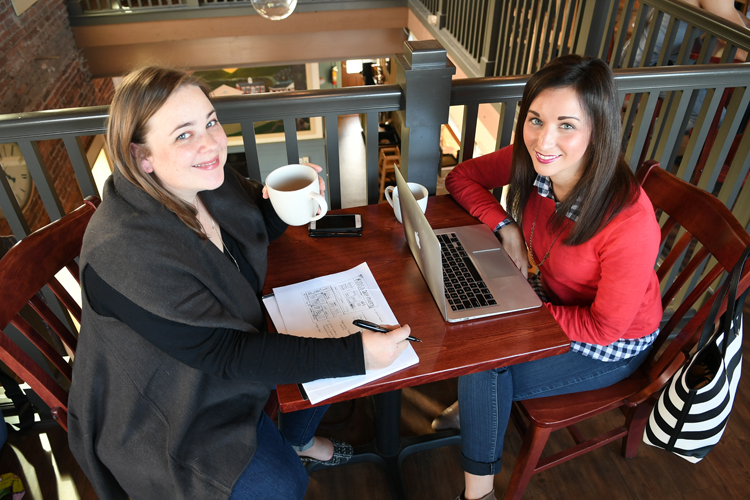 Riveter Design's Jordan Hegyi, and Lauren Molenda during a work meeting at Spot Coffee in Orchard Park, New York