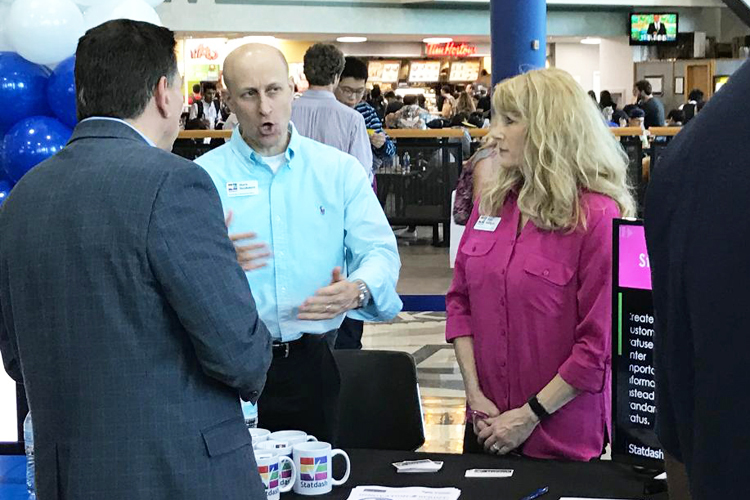 Mark Nusbaum, left, and Pam Nelligan, co-founders of Statdash, talk about their product during the entrepreneurial demos at the UB Entrepreneurs Festival.