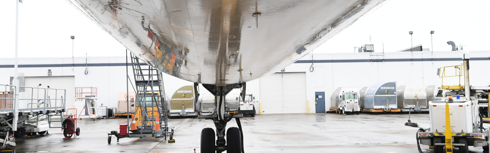 The underside of a jet plane on the tarmac of Buffalo Niagara International Airport