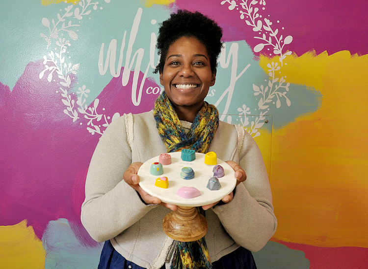 Michele Ogden, the owner of Whimsy Confections, with some of her artistic chocolates.