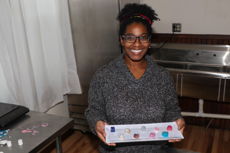 Michele Ogden of Whimsy's Confections plates her holiday collection of chocolates inside her Amherst Street storefront.