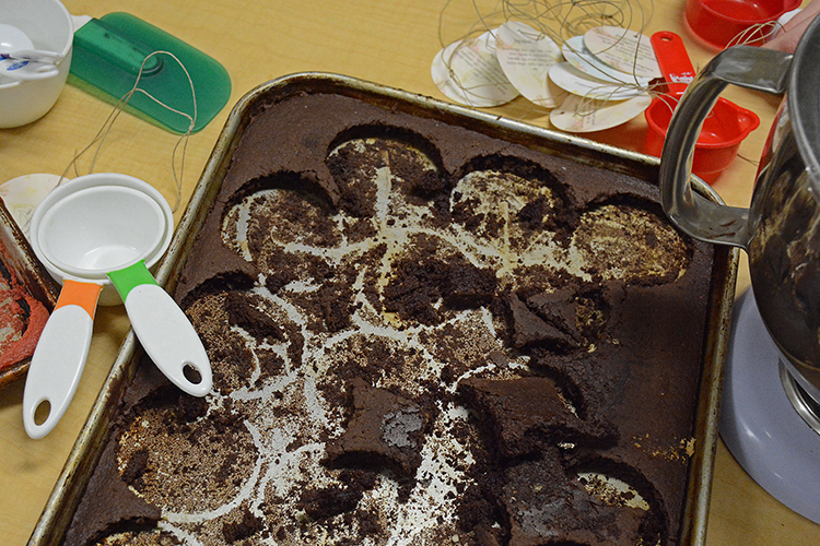 The students cut cake from a sheet pan to make their Stars in Jars.