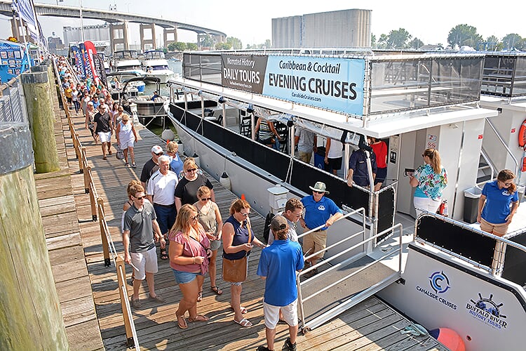 Captain Rich Hilliman welcomes passengers aboard The Harbor Queen, where they will learn about the history of the Buffalo River.