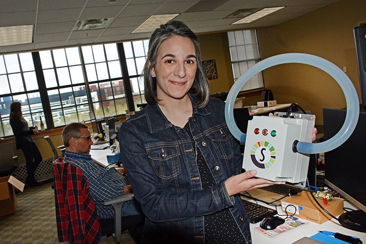 SomaDetect CEO and founder Dr. Bethany Deshpande holds a sensor.