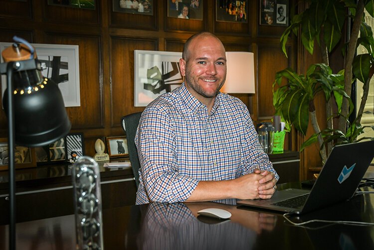 Steve Kiernan II sits in his office decorated with family mementos and abstract art.