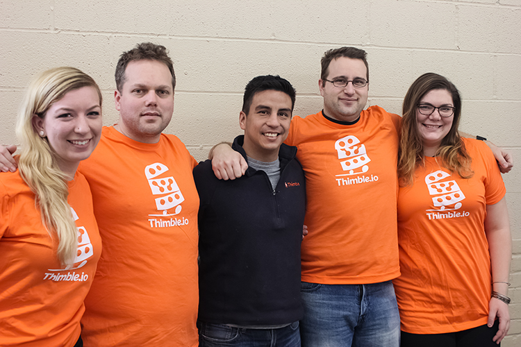 Co-founders Oscar Pedroso and David Brenner with their team at their new Thimble headquarters in the Pierce Arrow Administration Building on Elmwood Avenue.