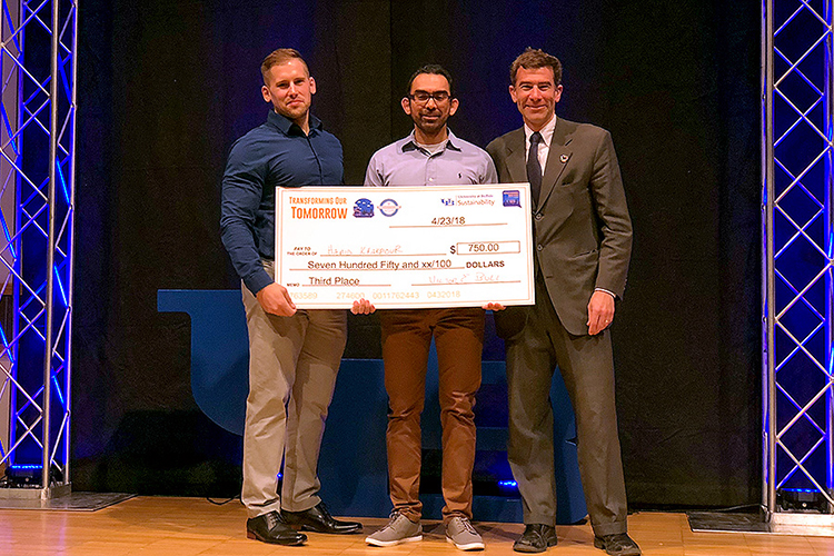 UB Ph.D. candidate Hamid Khakpour Nejadkhaki accepts an award in UB’s Transforming Our Tomorrow clean energy pitch competition for his design of a more aerodynamic and efficient wind turbine blade.