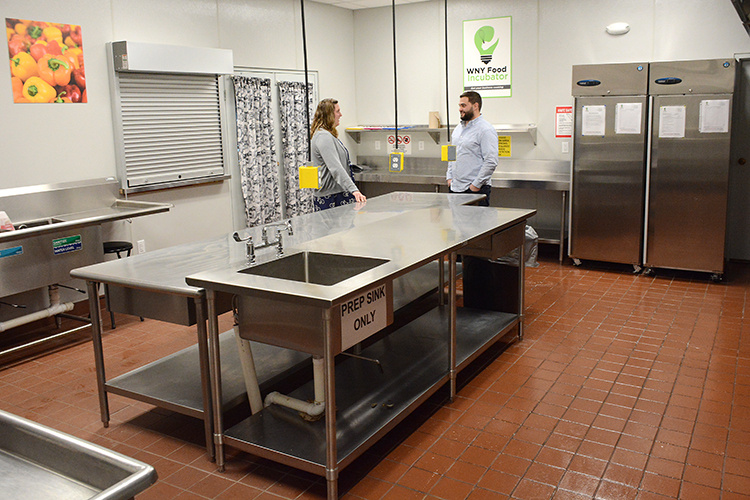 Amanda Henning talks to Marc Ducharme, Cornell Cooperative Extension public relations and marketing coordinator, in the WNY Food Incubator, a NYS certified kitchen that can be used by area chefs.